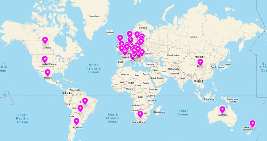 A world map with pink location pins. 